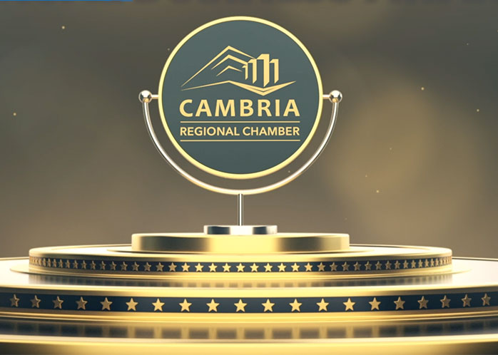 Gold emblem with the logo for the Cambria Regional Chamber.
