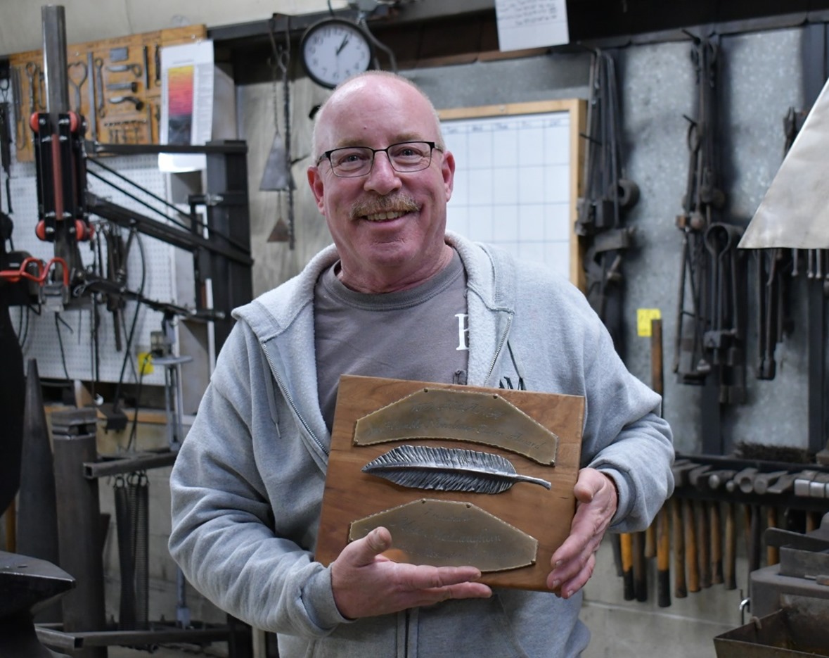 Mike McLaughlin holding the 2022 Joe Humble Newsletter Editor of the Year Award from ABANA.